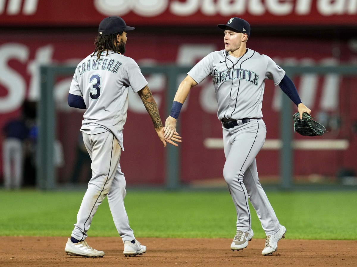 Sep 17, 2021; Kansas City, Missouri, USA; Seattle Mariners center fielder Jarred Kelenic (right) celebrates with shortstop J.P. Crawford (3) after defeating the Kansas City Royals at Kauffman Stadium.